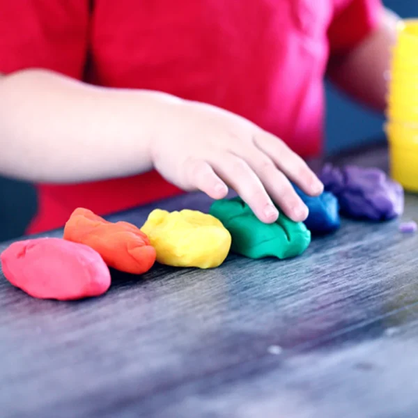 Child playing with playdough.